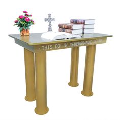 a table with books and a cross on it that says, this do in remembrance of me