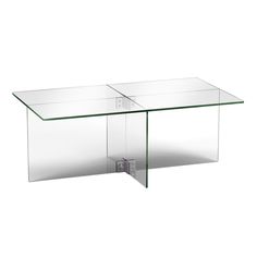 a glass table that is on top of a white surface with no people around it