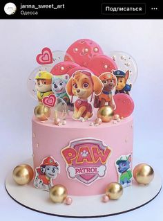 a pink cake topped with lots of dogs and hearts