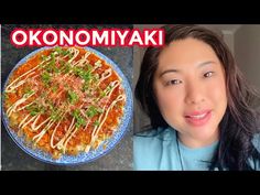 a woman with long hair standing in front of a plate of food and the words okonomiyaki on it