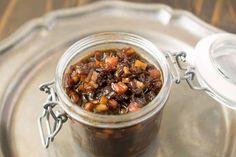 a glass jar filled with food sitting on top of a metal tray