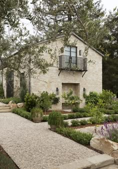 a stone house with landscaping around it