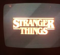 an old television with the words strange things on it