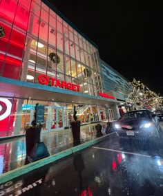 a car is parked in front of a target store with christmas lights on the windows