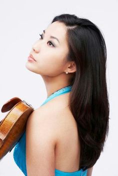 a woman holding a violin in her right hand