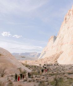 a group of people standing in the desert