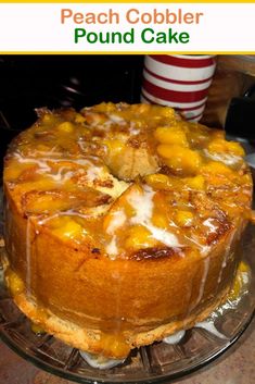 a cake sitting on top of a glass plate covered in icing and toppings