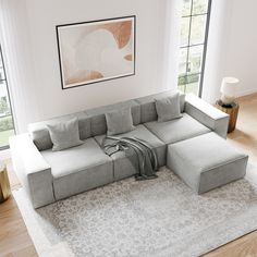 a living room with a sectional couch and rug