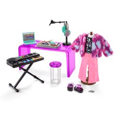 a doll is standing next to a desk with a keyboard and musical equipment on it