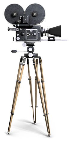 an old fashioned movie camera with tripod on white background stock photo - 51978