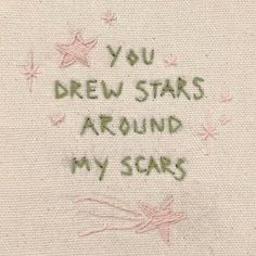 the words you drew stars around my scars are written in green ink on a beige background