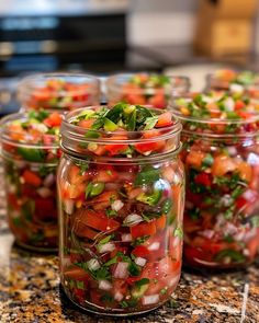 several jars filled with different types of vegetables