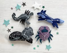 three felt animals and stars on a table