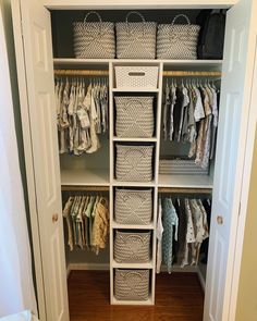 an organized closet with baskets and clothes