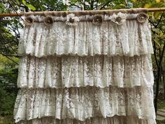 an old lace curtain hanging on a clothes line