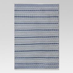 a blue and white rug on a gray background