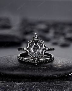 a diamond ring sitting on top of a rock