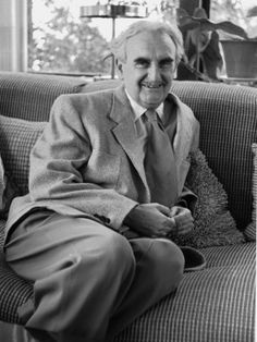 an old photo of a man sitting on a couch