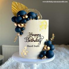 a birthday cake decorated with blue and gold decorations