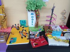 a table topped with lots of different types of paper and crafting items next to a sign