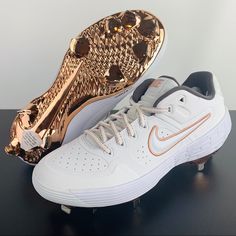 a pair of white and gold nike shoes