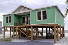 a car is parked in front of a house on stilts with stairs to the second floor