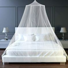 a bed with a white mosquito net over it