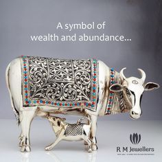 a statue of a cow with an ornate design on it's body and the words, a symbol of wealth and abundance