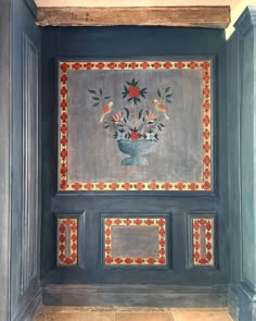 a painting on the side of a wall with flowers in a vase painted on it