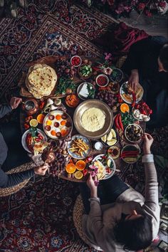 two people sitting at a table full of food