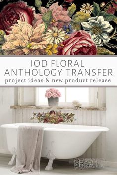 an old fashioned bath tub sitting next to a window with flowers on the wall above it