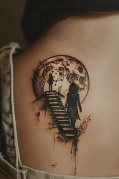 a woman's back with a tattoo on her stomach and stairs leading up to the moon