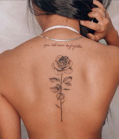 a woman with a rose tattoo on her back