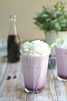 two glasses filled with ice cream on top of a wooden table