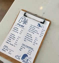 a menu on a clipboard sitting on top of a table