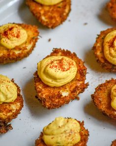 some food that is sitting on a white plate and has yellow icing on it