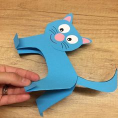 someone is making a cat out of paper