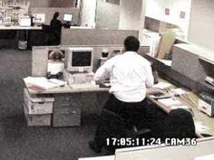 an office cubicle with two people working on computers and one person sitting at the desk