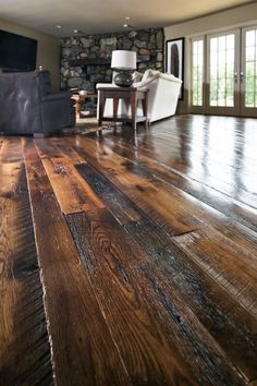 a living room filled with furniture and wooden floors