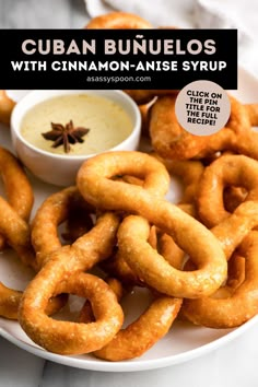 a plate with onion rings and dipping sauce