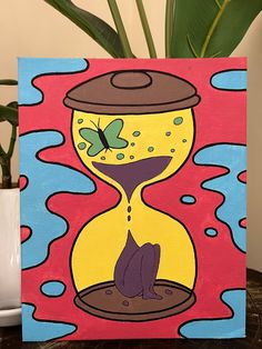 a painting of an hourglass with a cat on it sitting next to a potted plant