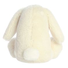 a white stuffed animal sitting up against a white background