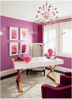 a living room with purple walls and furniture in the center, along with pictures on the wall