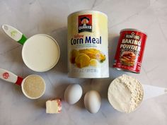 ingredients to make chicken broth laid out on a marble counter top, including eggs, flour, butter and seasoning