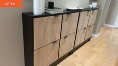 a wooden cabinet with drawers and a white vase sitting on it's sideboard