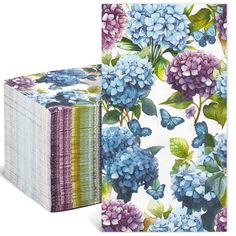 two boxes with blue and purple flowers on them, one is folded up to the side