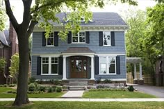 a blue house with white trim and black shutters