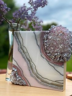 a vase filled with purple flowers on top of a table