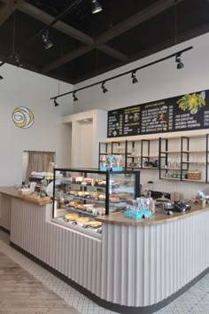 the inside of a deli with lots of counter space and signs on the wall