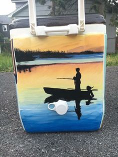 a cooler with a painting of a man in a boat on the water